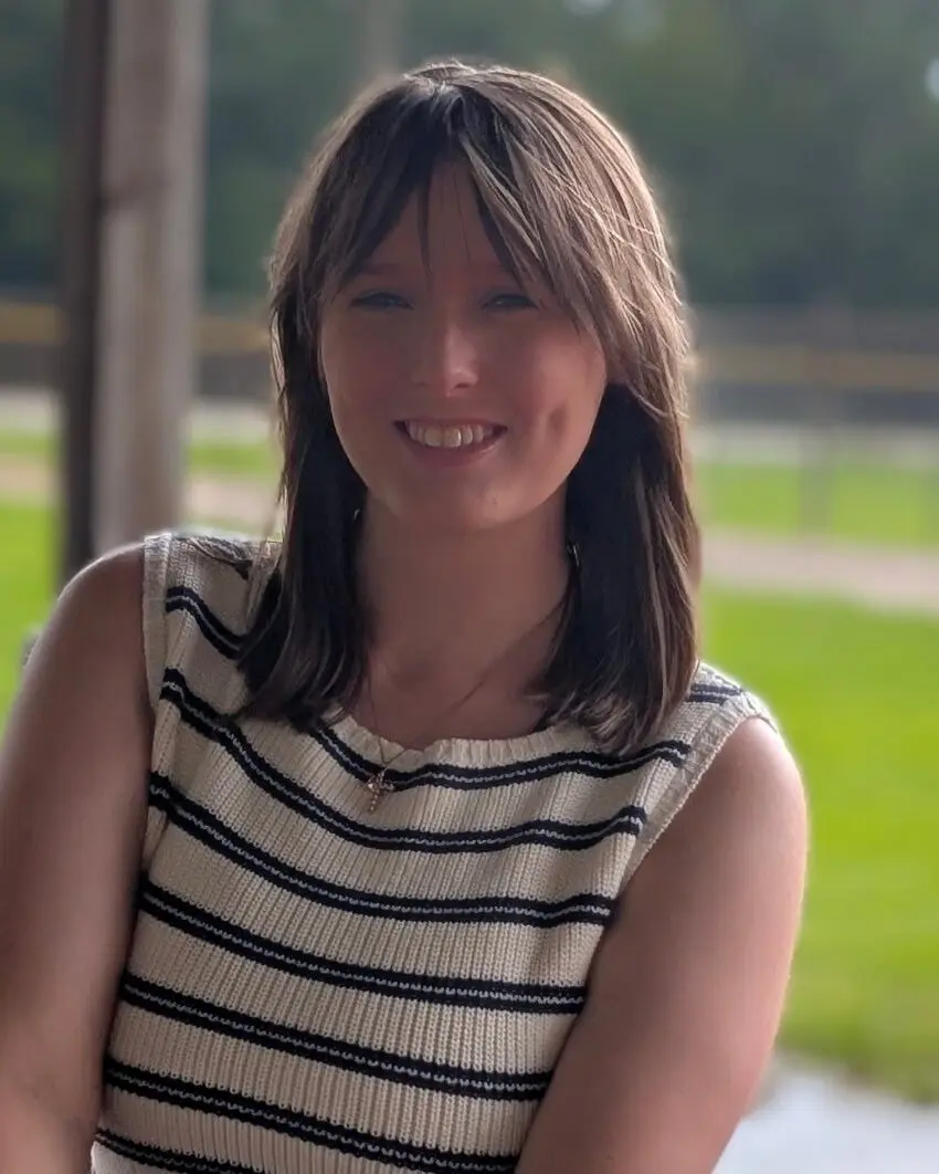 Brea Gaillard sitting at a picnic table on a summer day